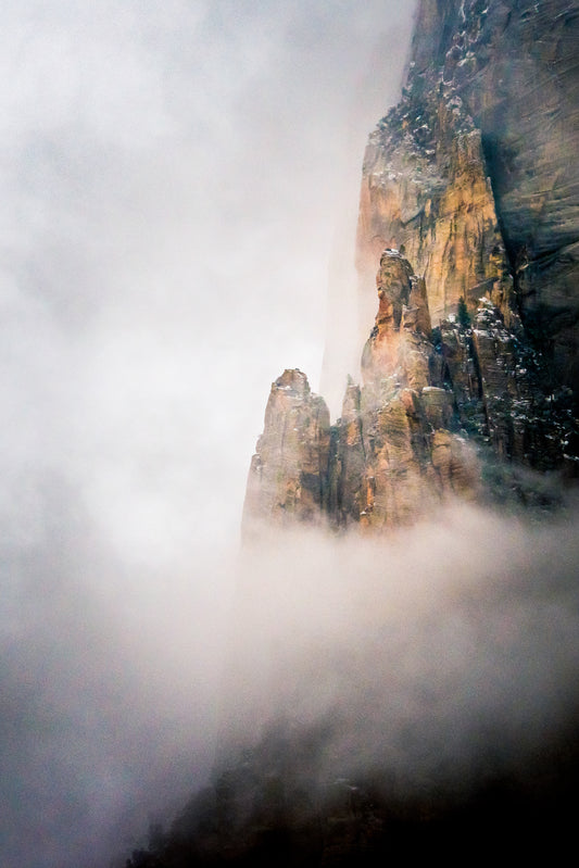 Rare mist fills Zion Canyon and makes the mighty walls look as if they are just in the process of being created. I waited hours for the mist to clear in this spot, and just as it did a light hole broke in the clouds and made the scene glow. 