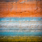 A beautiful gradient of green, blue, white, grey, red, orange, and black of the Glen canyon walls, sitting over the waters of Lake Powell, Utah. The colors tell the story of changes in water levels, minerals, and chemistry in the lake over time. As if time painted its story on the walls. 